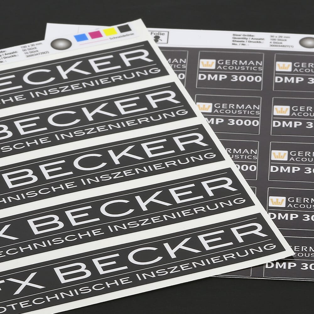 Heller Vinyl-Folienaufkleber von Orafol mit schwarzem Hintergrund und weißen Standard-Designs, für Dekoration und Gestaltung.