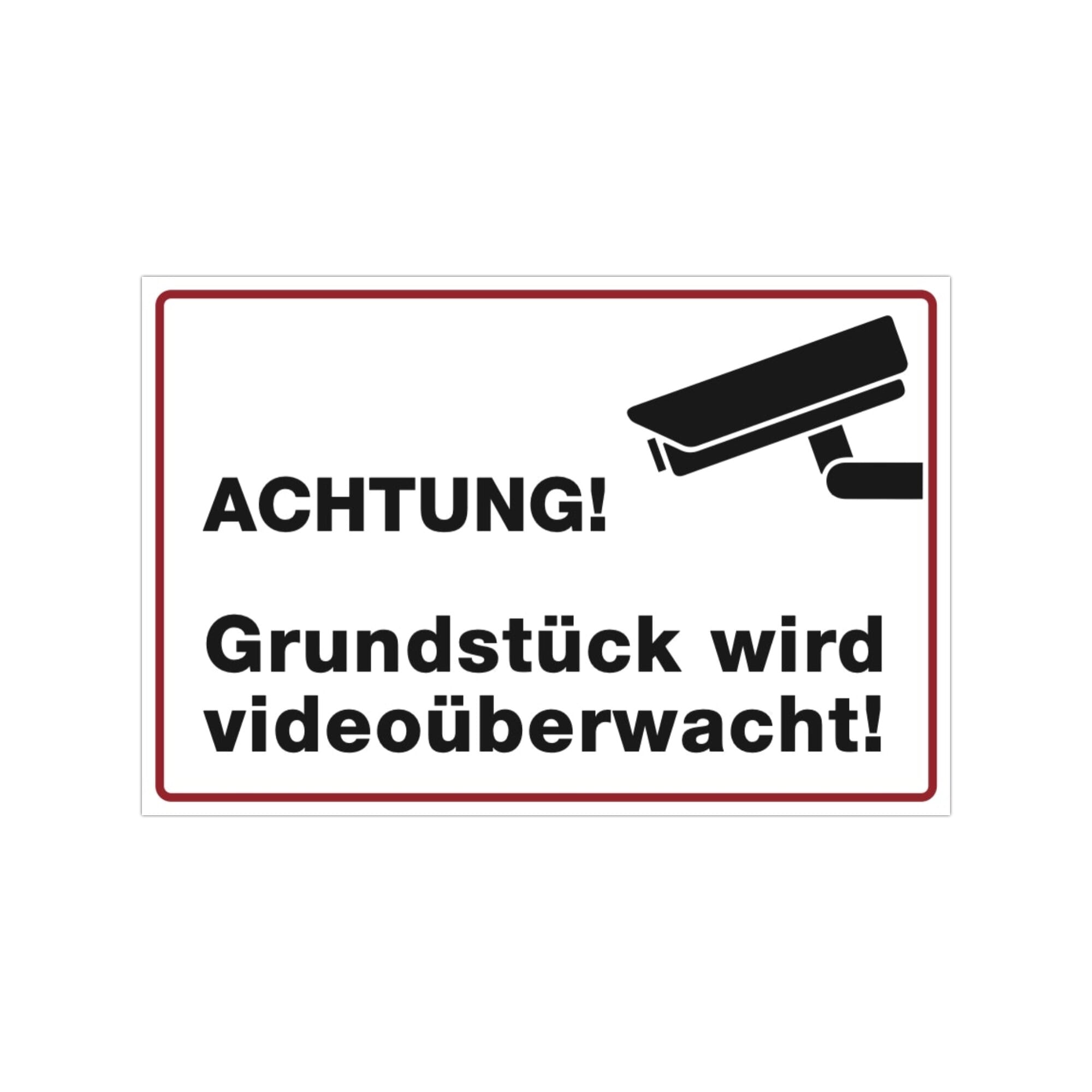 Drei weiße Aufkleber mit dem Hinweis „Achtung! Grundstück wird videoüberwacht“, 300x200 mm, auf einer Oberfläche.